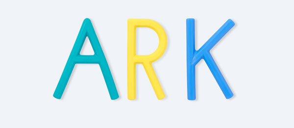 Three letter-shaped handheld chews from left to right: teal A, yellow R, and blue K