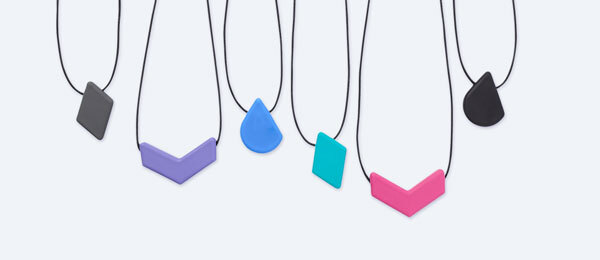 Six chew necklaces hanging in a row from left to right