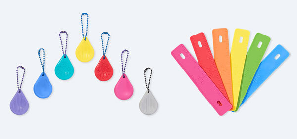 A colorful array of worry stone fidgets on the left and binder fidgets on the right
