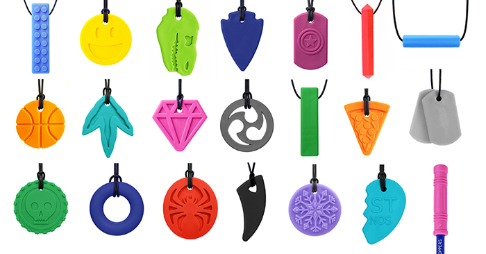 A display of 21 different ARK chew necklaces in different shapes and colors