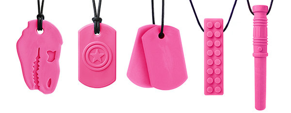 From left to right: Dino-Bite, Super Star, Chew Tags, Brick Stick, and Bite Saber chewable necklaces in pink