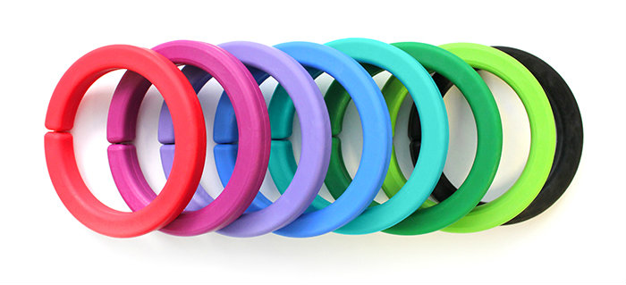A stack of chewable bracelets in 8 colors