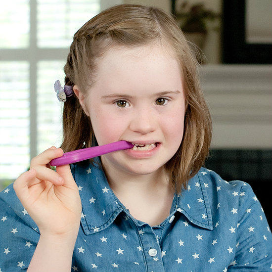 Can't Eat by Mouth, but Still Want/Need to Chew? A girl bites down on the stem of the ARK Grabber P chew