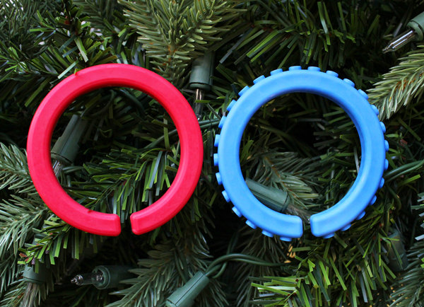Oral Sensory Stocking Stuffer Ideas A side by side comparison of the smooth versus textured ARK chewable bracelets on a Christmas tree backdrop