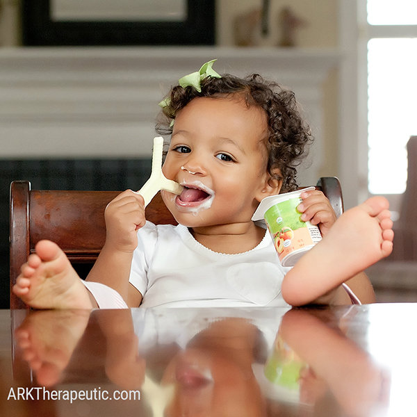Which Products Are Recommended for Drooling? A young girl chews on the yellow Y-Chew