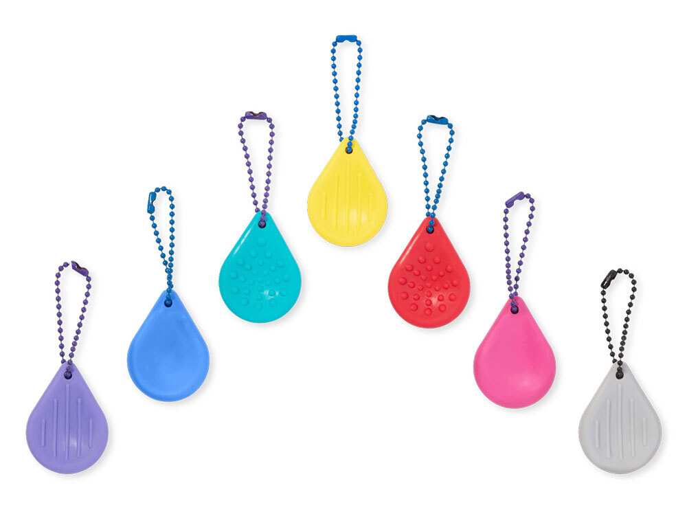 Key Tips to Help Kids Stay Regulated through the Holidays Collection of colorful worry stone style keychains with varying texture