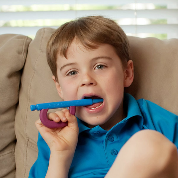 Bite Reflex While Toothbrushing Boy sitting on a couch with the Z-Brush